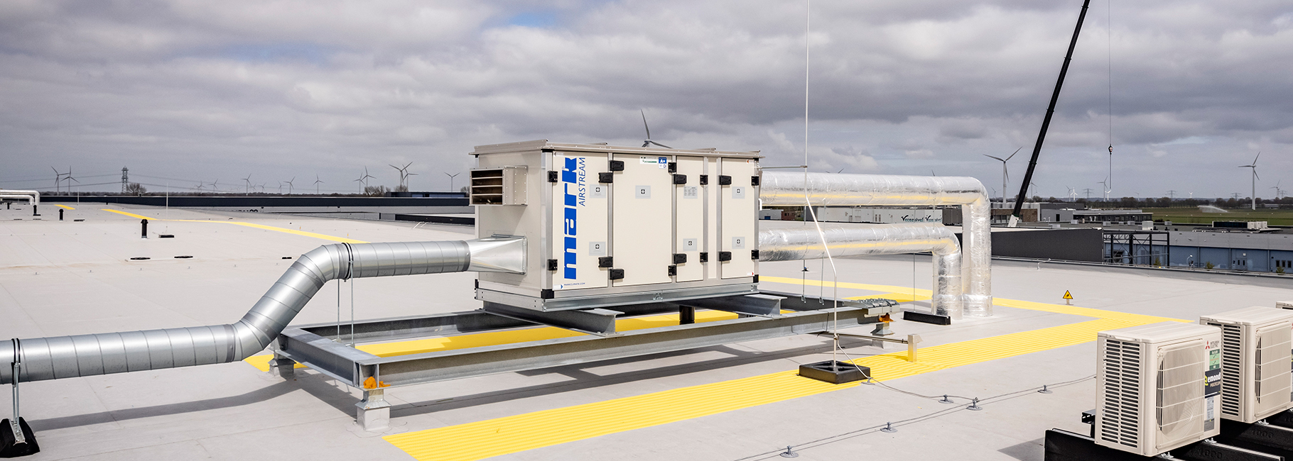 A Mark Airstream heat recovery unit with air ducts installed on a roof